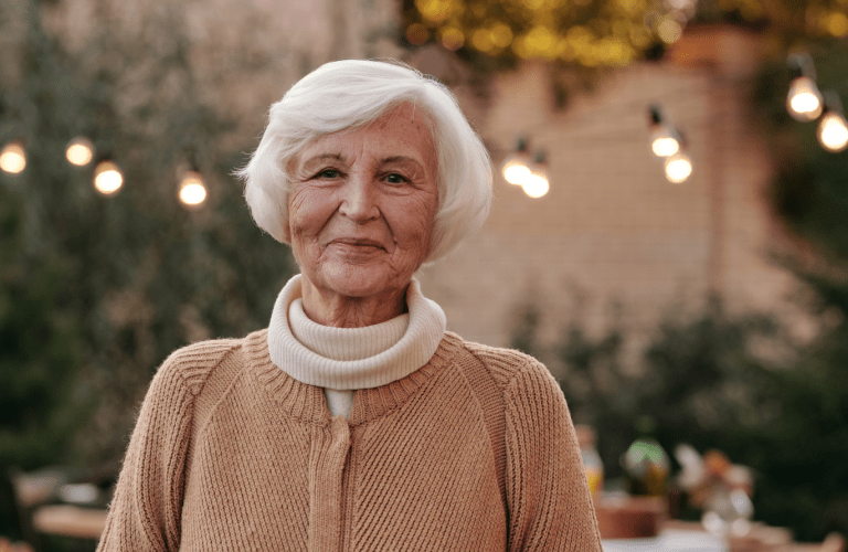 smiling elderly woman in a care home garden